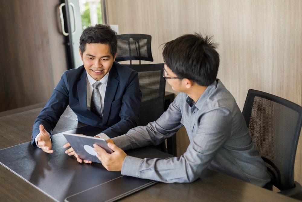 Guy and a guy discussing using a tablet