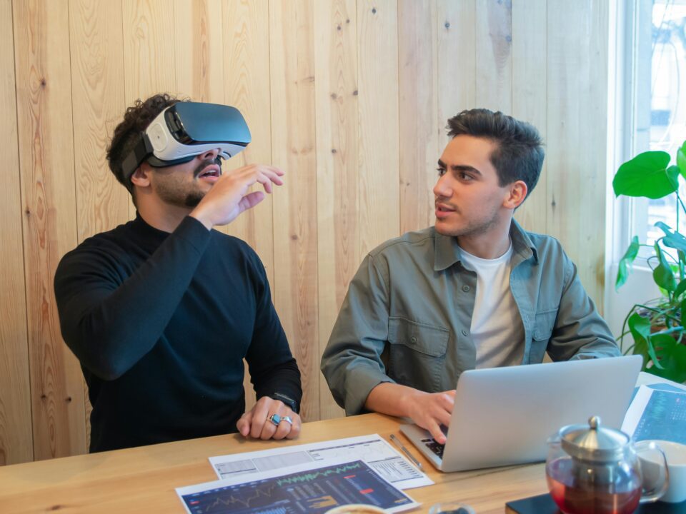 Two young participants try out AR VR headset at a business conference.